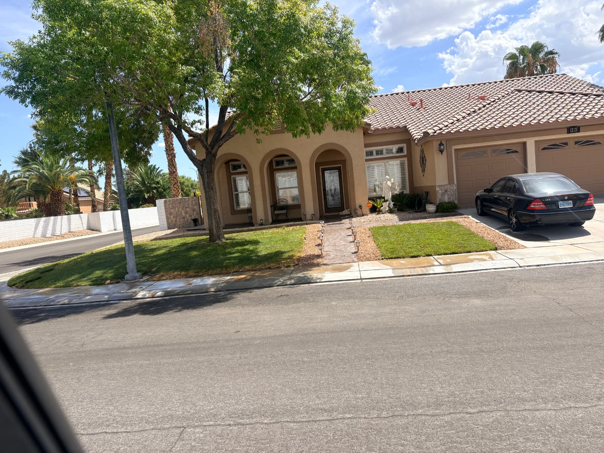 Front yard lawn and rock landscaping with paver walkway